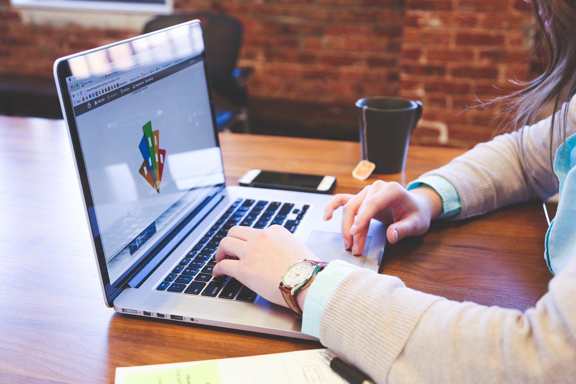 A creative designer working on a laptop.